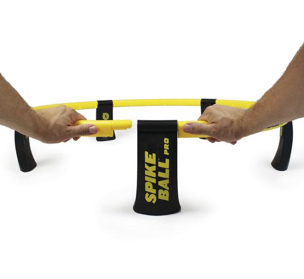 Hände montieren das gelbe Spikeball Pro Netzgestell auf weißem Hintergrund.